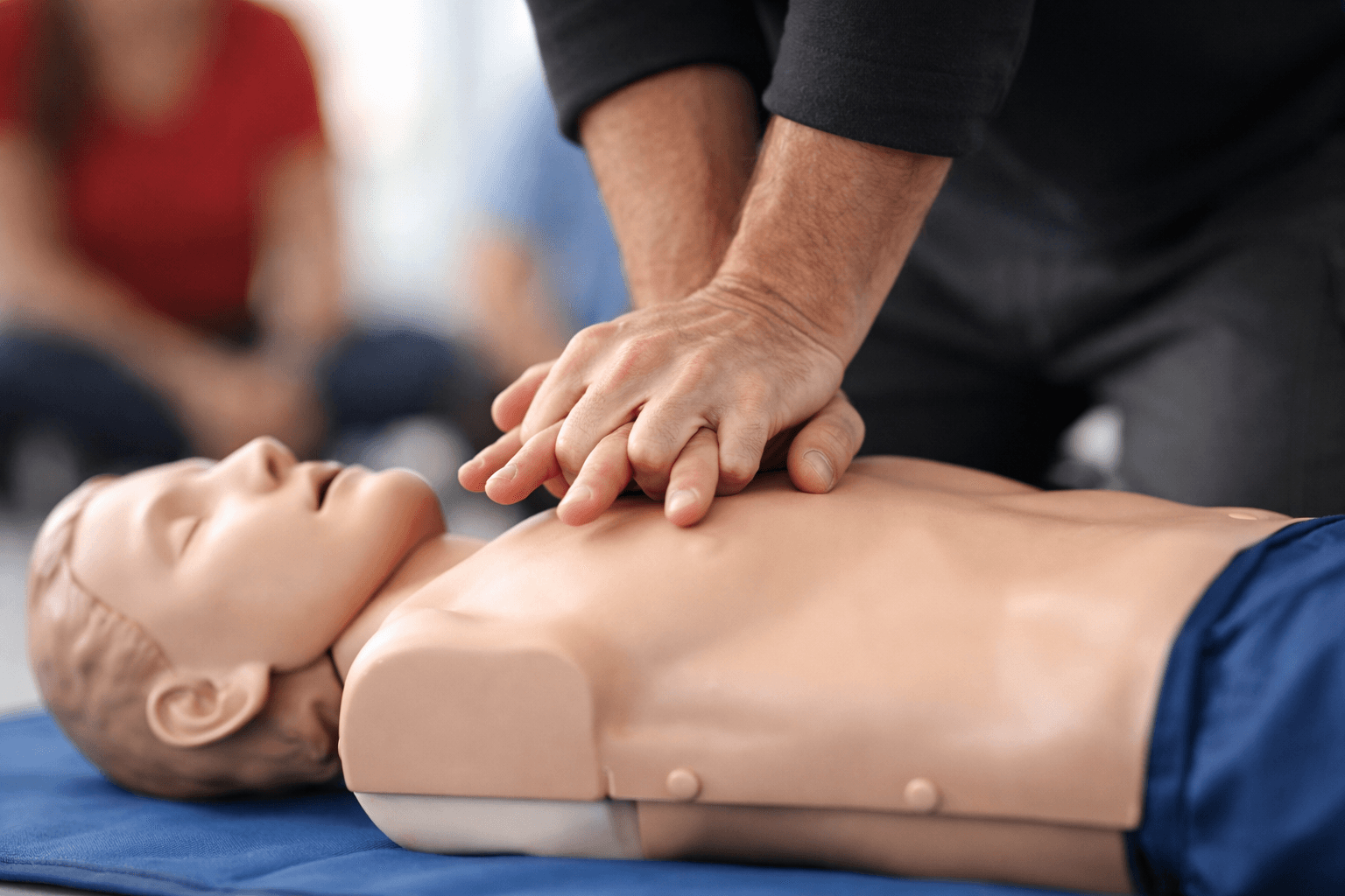CPR Level C training with participants practicing chest compressions and rescue skills